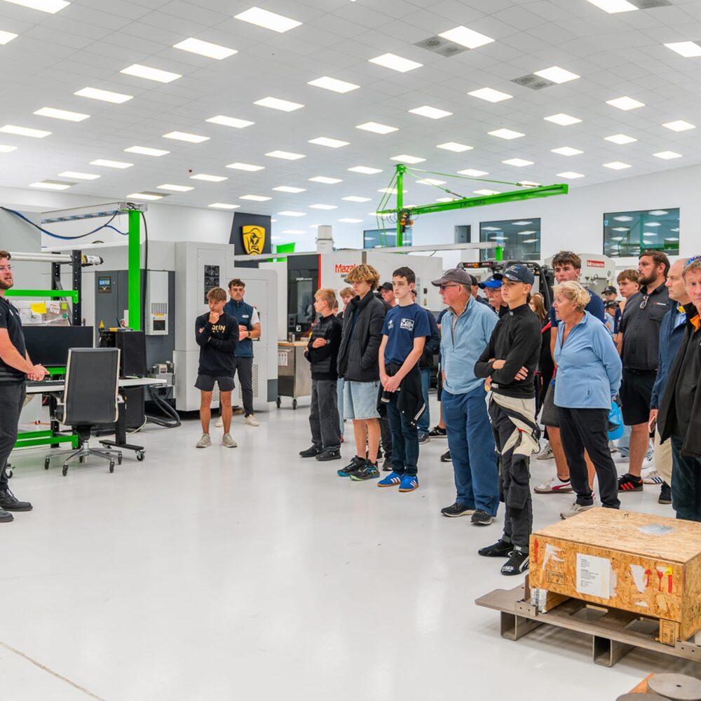 6-Visitors_get_a_guided_tour_through_the-manufacturing-facilities.